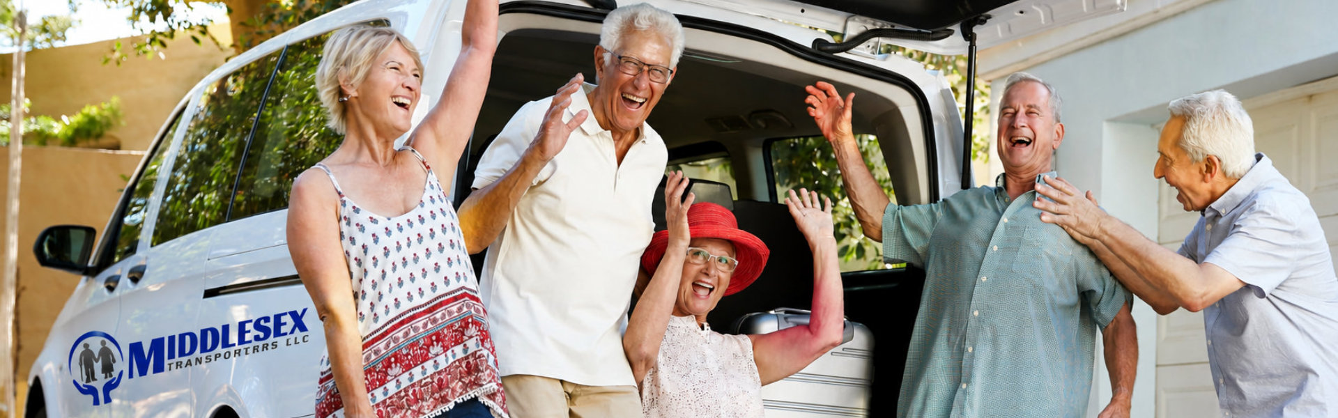 Portrait Of Excited Senior Friends Loading Luggage Into Trunk Of Car About To Leave For Vacation
